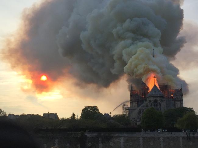 Flames and smoke are seen billowing from the roof at Notre-Dame Cathedral in Paris on April 15, 2019. (Photo by Fouad Maghrane / AFP)