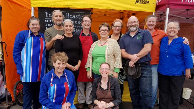 Grateful stallholders at the Geeveston Fireys Feast included, back row from left Kimberley Ashworth (American Pi), David and Donna Peyr (Pocket Curries), David Rolph (Deep End Farm), Karan Spilling (The Princess and the Fatman), Katie Devenish (Yeastie Beasties), David Spilling (The Princess and the Fatman), event organiser Cassy Faux, and Becky Phillips (Our Place in Paradise). Front: Anne Riley (American Pi) and Michelle Ewikowski (Michelle’s Roundhouse). Picture: ELAINE REEVES