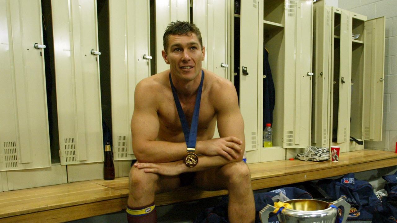 28/09/2002. Alastair Lynch in the rooms with the premiership cup. Premiership medal. 2002 Grand Final. Brisbane Lions v Collingwood. MCG.