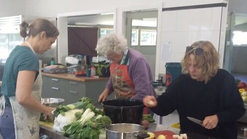 Three volunteers in Bellingen have helped provide more than 7000 meals this year for the Pete’s Place community. Picture: Supplied