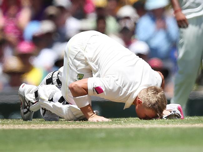 Australia's David Warner kisses the turf in the spot where Phillip Hughes was felled as he reaches 63 during his innings on Day 1 of 4th Test Australia v India at the SCG. Picture: Phil Hillyard