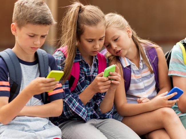 Children using smartphone devices at school. Picture: iStock.