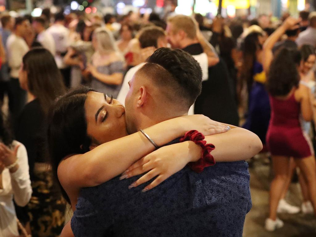 People kissing in the street during the start of the new year, New Year's Eve 2020, Fortitude Valley, Brisbane. Photographer: Liam Kidston.