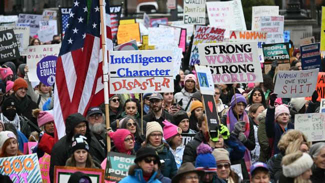 Protesters held signs that spanned the past eight years of Trump-era progressive activism. Picture: AFP