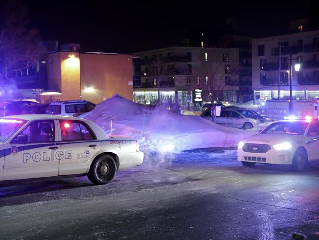 Police survey the scene after deadly shooting at a mosque in Quebec City, Canada. Picture: Francis Vachon/The Canadian Press via AP