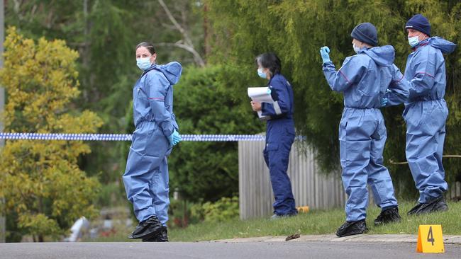 Forensic police search surrounding streets after the home invasion. Picture: Hamish Blair