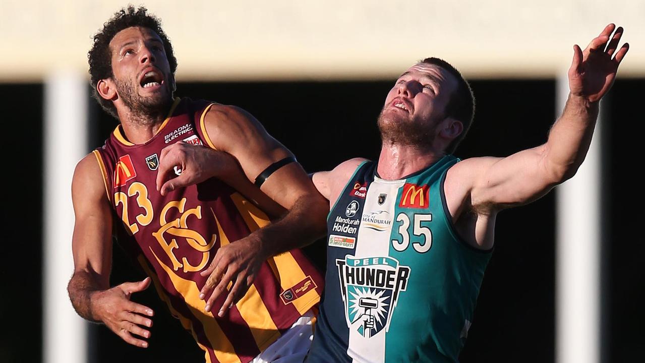 Zac Clarke competes for a ball against Peel Thunder ruckman Michael Apeness.