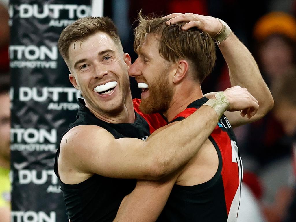 MELBOURNE, AUSTRALIA – JUNE 23: Zach Merrett (left) and Dyson Heppell of the Bombers celebrate during the 2024 AFL Round 15 match between the Essendon Bombers and the West Coast Eagles at Marvel Stadium on June 23, 2024 in Melbourne, Australia. (Photo by Michael Willson/AFL Photos via Getty Images)