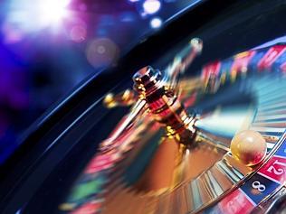 Roulette wheel in motion with a bright and colorful background
