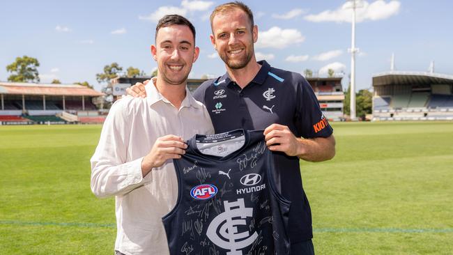 Sam Docherty gives Liam Contarin a signed jumper. Picture: Jason Edwards