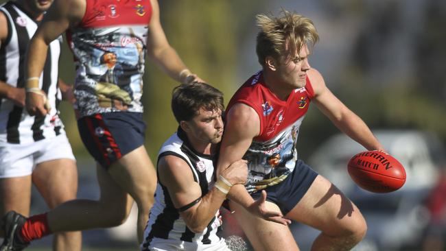 SFL grand final rematch - Flagstaff Hill v Reynella. Reynella's Simon Karran tackles Flagstaff Hill's McKenzie Short.  27 April 2019. (AAP Image/Dean Martin)