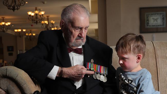 World War II veteran John Macdonald talks about his medals from his time in the Pacific to great grandson Connor Evans 4.  John was chatting about his experiences to mark the 75th anniversary of the end of World War II on August 15, 1945. John Lives at the Aveo The Domain Country Club. Picture Glenn Hampson