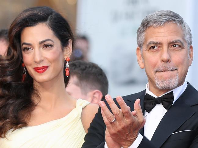 (FILES) This file photo taken on May 12, 2016 shows US actor George Clooney (R)and  his wife British-Lebanese lawyer Amal Clooney arriving for the screening of the film 