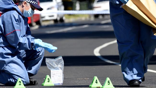 Forensic pick up spent shells from the road. Police investigate after a man and a child are in hospital after a shooting at a Thomastown home in Darebin drive. Picture: Nicole Garmston