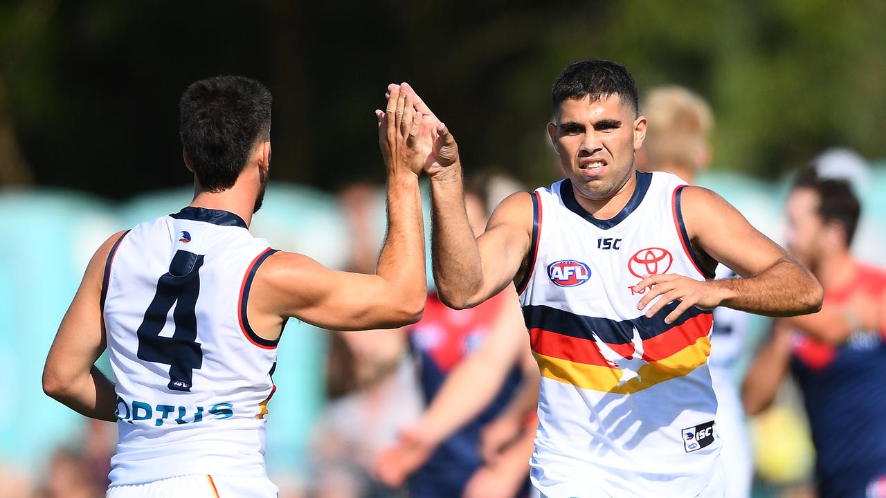 MELBOURNE, AUSTRALIA - FEBRUARY 22: Tyson Stengle of the Crows is congratulated by team mates after kicking a goal during the 2020 Marsh Community AFL Series match between the Melbourne Demons and the Adelaide Crows at Casey Fields on February 22, 2020 in Melbourne, Australia. (Photo by Quinn Rooney/Getty Images)