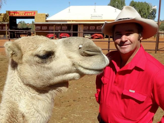 Lisa Evans and Chris Hill from Uluru Camel Tours, with Rex the camel at their Yulara camel farm, the largest in the Southern Hemisphere. Picture: LISA EVANS