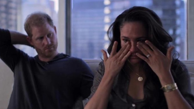 Snippets from the series see Meghan wiping her eyes as Prince Harry looks on. Picture: Netflix