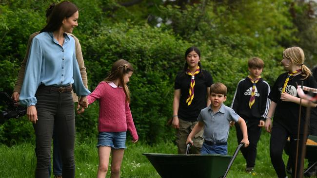 Prince Louis and Princess Charlotte walk with their mother, Catherine, Princess of Wales while taking part in the Big Help Out. Picture: WPA Pool/Getty Images.