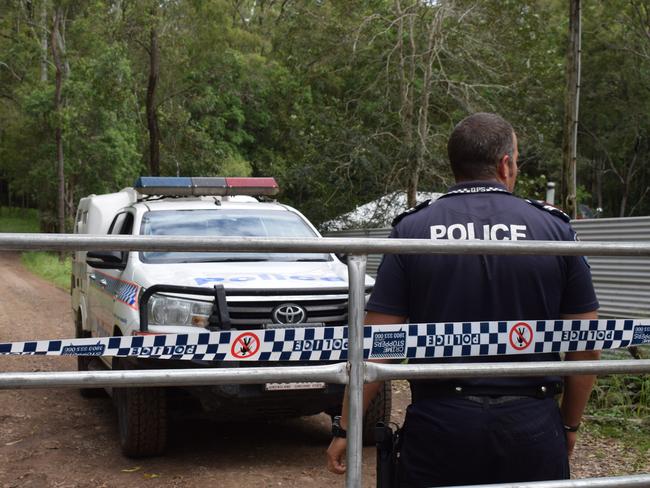 Imbil police senior constable Bill Greer guards the entrance to an Amamoor property, where someone was allegedly murdered on Thursday.