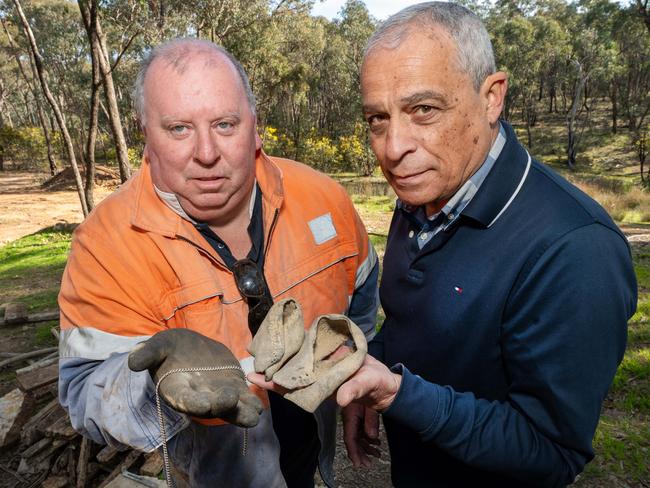 Terry’s brother Daryl Floyd and former homicide Charlie Bezzina hold a necklace and remains of shoes that maybe evidence. Picture: Rob Leeson