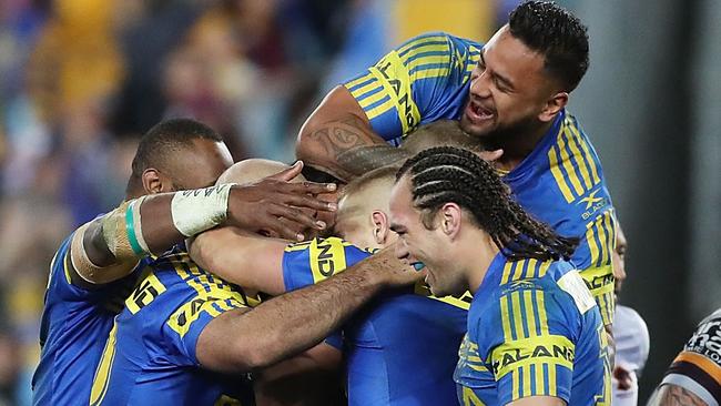 Bevan French (unseen) of the Eels celebrates scoring a try.