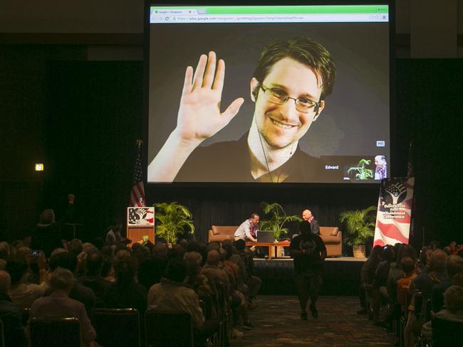 NSA leaker Edward Snowden appears on a live video feed broadcast from Moscow at an event sponsored by the ACLU Hawaii in Honolulu on Saturday, Feb. 14, 2015. (AP Photo/Marco Garcia)