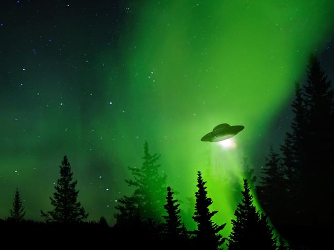 UFO landing at night in the forest with trees and stars.