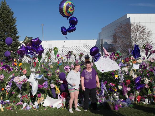 The fence outside of Prince’s home and studio was decorated with purple flowers, messages and balloons. Picture: Scott Olson/Getty Images.