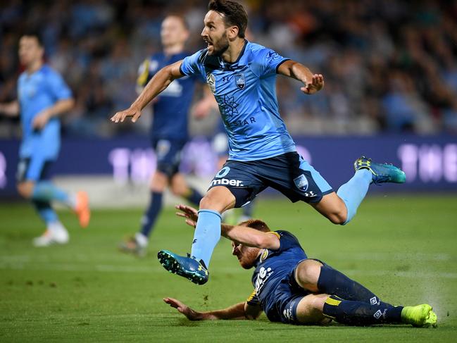 Milos Ninkovic of Sydney is tackled by Ian Zygmunt Gordon of the Mariners during the Round 10 A-League match between the Sydney FC and the Central Coast Mariners at Netstrata Jubilee Stadium in Sydney, Saturday, December 14, 2019. (AAP Image/Dan Himbrechts) NO ARCHIVING, EDITORIAL USE ONLY