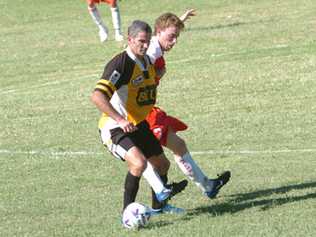 OLD HAND: Craig Foster, left, takes on a Workers opponent in the inaugural Corey New Cup match in 2007.