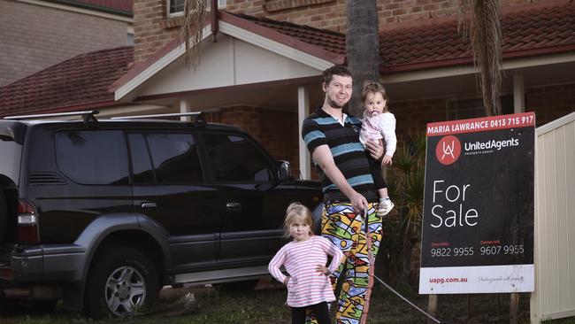 Kyle Sinclair and his 2 daughters  Zara 1 year old (Held in his arms) and Amelia 4 years old standing, photographed at  13A Wesley Place, Horningsea Park. . Thursday , 2 August  2018.Kyle Sinclair and his family are about to start looking for their next home Kyle: 0421545021(The Daily Thelegraph / Flavio Brancaleone)