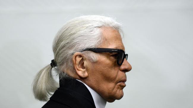 Picture taken on February 14, 2014 shows German fashion designer Karl Lagerfeld as he visits an exhibition at the Museum Folkwang in Essen, western Germany. - German fashion designer Karl Lagerfeld has died at the age of 85, it was announced on February 19, 2019. (Photo by Caroline Seidel / DPA / AFP) / Germany OUT