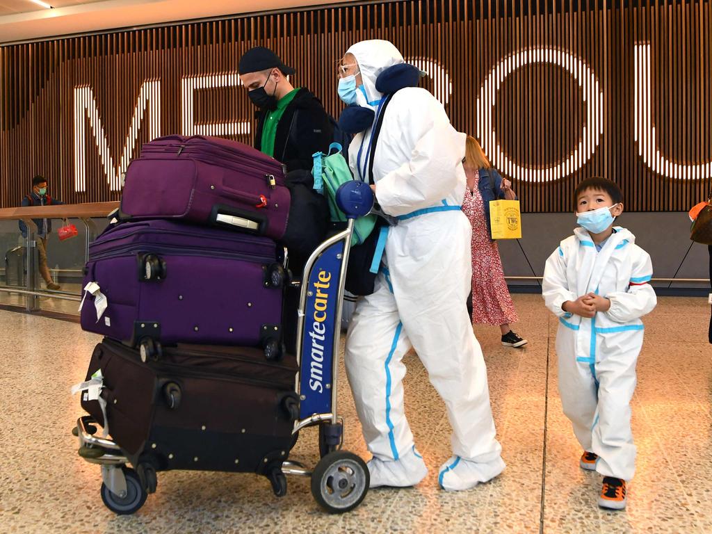 International travellers wearing PPE arrive at Melbourne's Tullamarine Airport as Australia records its first cases of Omicron. Picture: William West / AFP