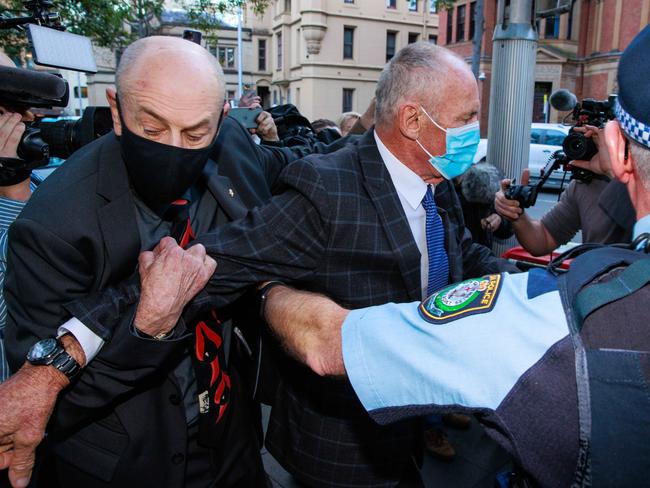 Daily Telegraph. 30, August, 2022.Peter and Paul Dawson are restrained by police after a scuffle with media as they leave the Supreme Court, Sydney, after a guilty verdict was passed down in their brother, Chris DawsonÃs, murder trial, today.  Picture: Justin Lloyd.