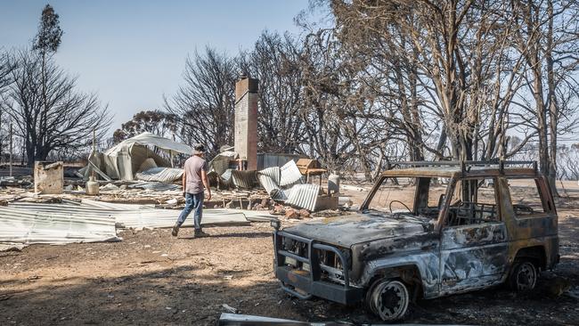 Joe Tippett surveys the site of the Flinders Chase National Park’s visitor centre, destroyed by fire. Picture: Sean McGowan