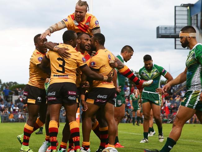 Stargroth Amean celebrates with team mates after scoring a try.