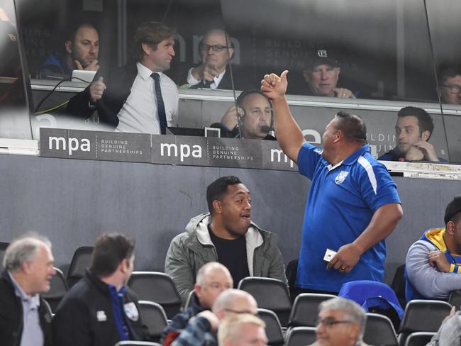 An Eels supporter gestures to Bulldogs head coach Des Hasler.