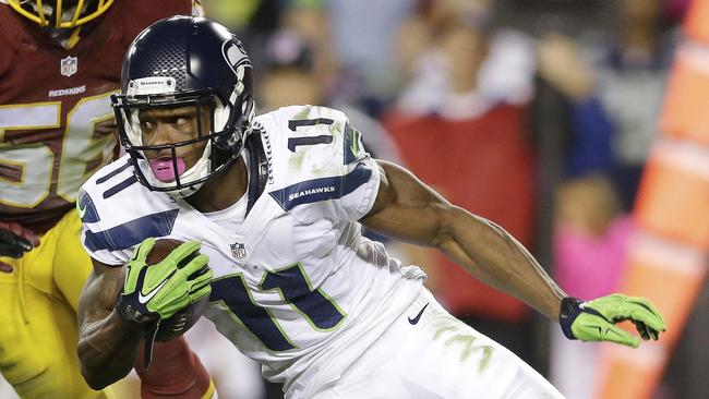 Seattle Seahawks wide receiver Percy Harvin (11) carries the ball past Washington Redskins inside linebacker Perry Riley (56) during the first half of an NFL football game in Landover, Md., Monday, Oct. 6, 2014. (AP Photo/Patrick Semansky)