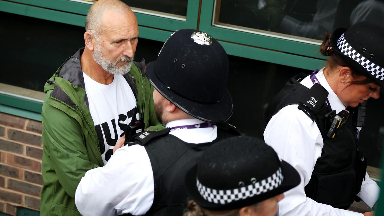 A just stop oil protester is escorted by police. (Photo by Michael Regan/Getty Images)