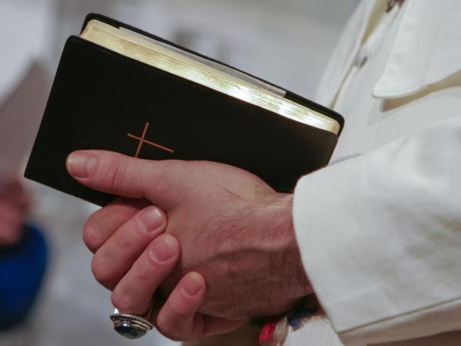 Man in popes garment holding holy bible. Adobe RGB for better color reproduction.