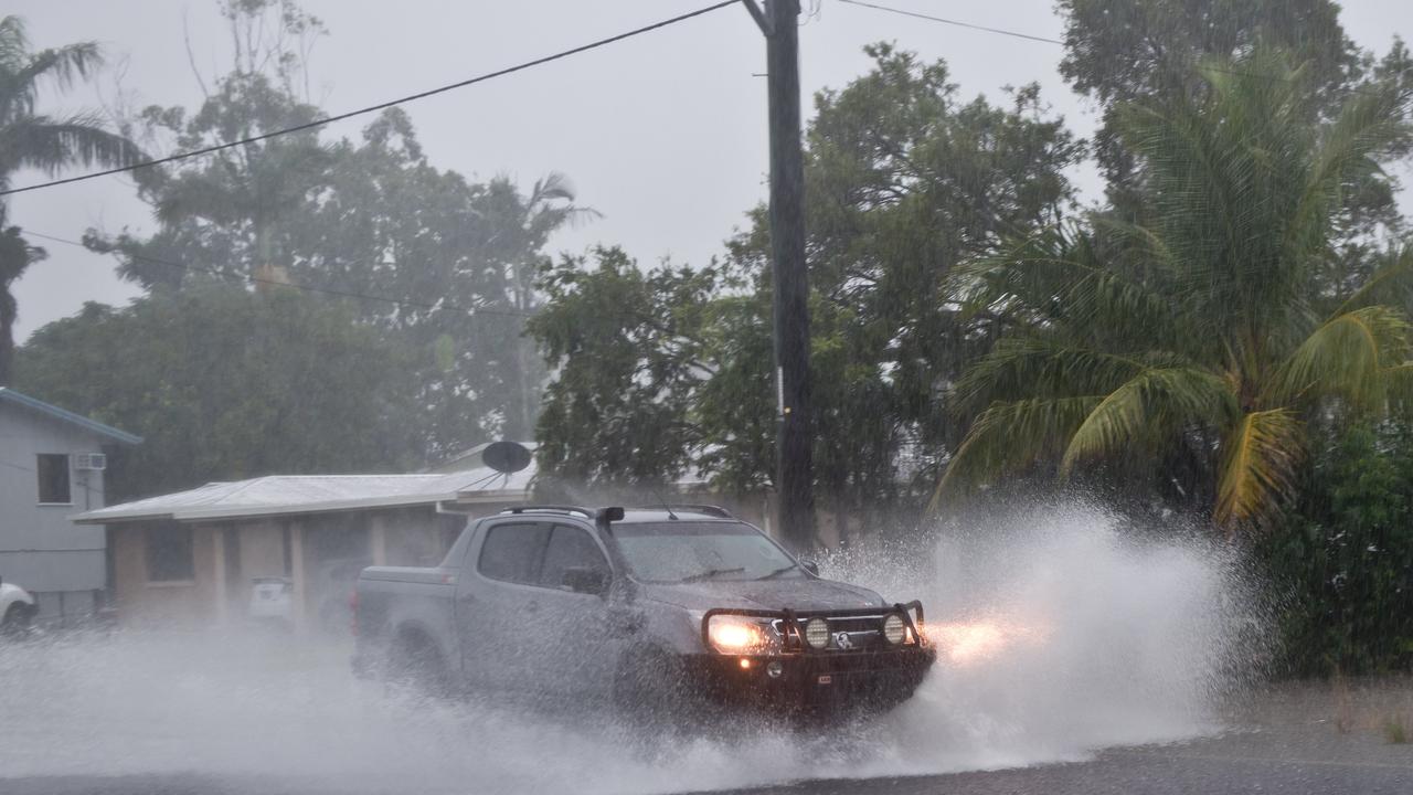 A car drives through heavy water on Mansfield Drive in Beaconsfield in 2020. Mackay weather.