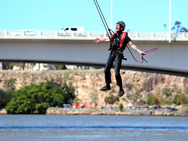 Pat Kinsella who has ALS/ MND swinging from the Goodwill Bridge to raise awareness on the disease. Photo: Jodie Richter