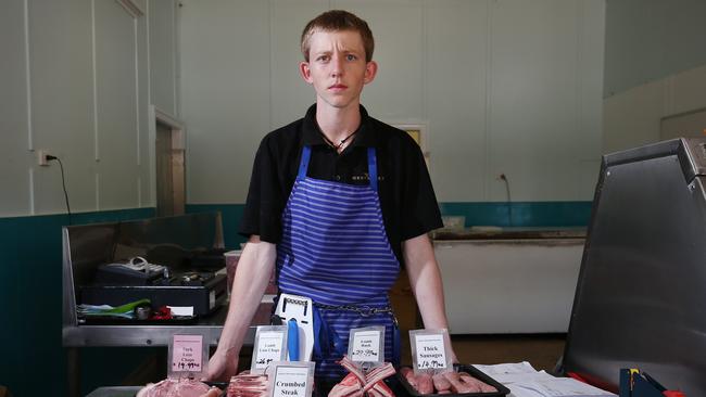 Apprentice butcher Leeroy Wilkes of Jensen's Ravenshoe Butchery on Ravenshoe's main street, on the Atherton Tablelands, where wanted fugitive Graham Gene Potter was often seen buying barbecue meats. Picture: Brendan Radke