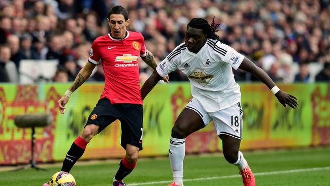 Angel Di Maria of Manchester United challenges Bafetimbi Gomis of Swansea.