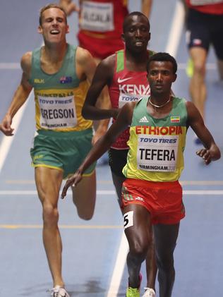 Ethiopia's Samuel Tefera, front, crosses the line ahead Kenya's Vincent Kibet and Australia's Ryan Gregson, left, in a men's 1500-metre heat at the World Athletics Indoor Championships.