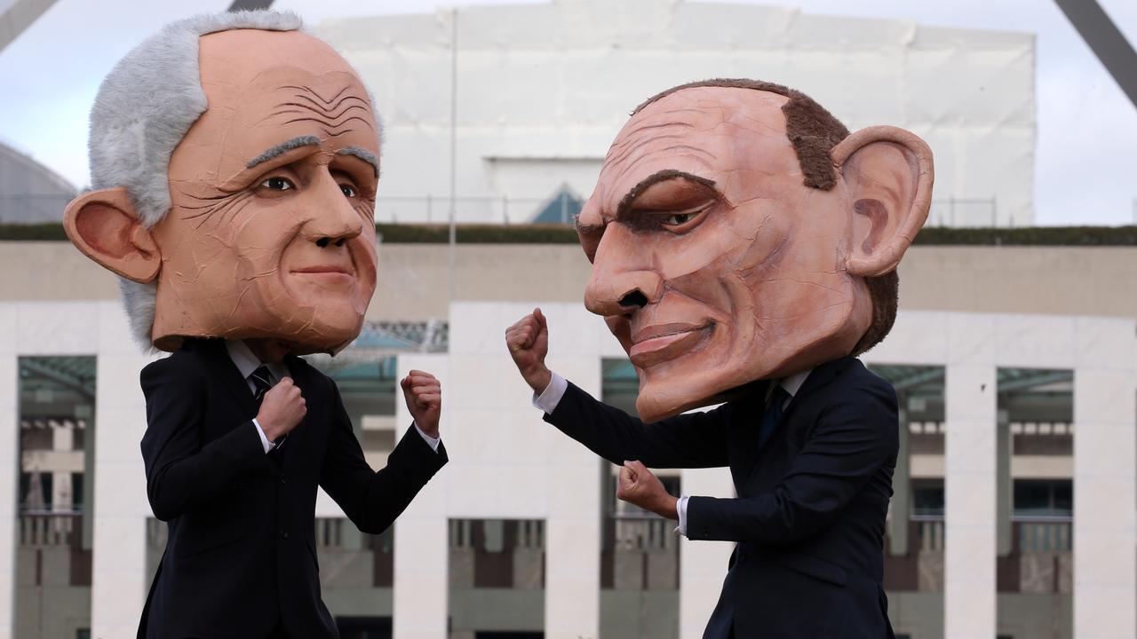 Two protesters wearing large heads depicting the Malcolm Turnbull and Tony Abbott on the lawns of Parliament House in Canberra. Picture: Gary Ramage