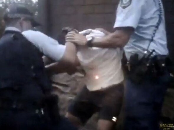 Police grapple with a man during the incident.