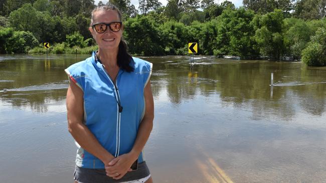 Donna Young shares her frustrations as Youngs Crossing Road floods. Picture: Marcel Baum