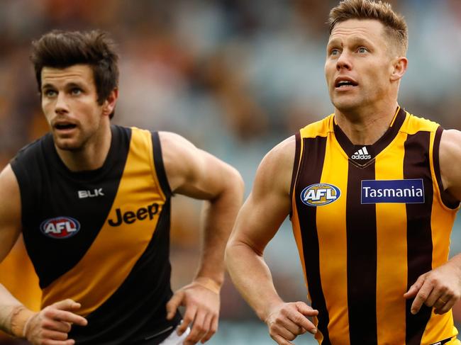 MELBOURNE, AUSTRALIA - JULY 24: Trent Cotchin of the Tigers and Sam Mitchell of the Hawks in action during the 2016 AFL Round 18 match between the Hawthorn Hawks and the Richmond Tigers at the Melbourne Cricket Ground on July 24, 2016 in Melbourne, Australia. (Photo by Michael Willson/AFL Media)