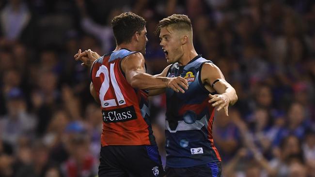 Tom Liberatore and Josh Schache of the Bulldogs react after Schache kicked a goal during the Round 1 AFL match between the Western Bulldogs and the Sydney Swans at Marvel Stadium in Melbourne, Saturday, March 23, 2019. (AAP Image/Julian Smith) NO ARCHIVING, EDITORIAL USE ONLY